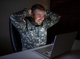 caucasian-soldier-army-uniform-front-computer-feeling-happy-excited-min